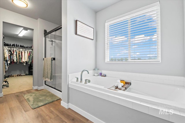 1499 W Blue Downs St, Meridian, ID 83642 - bathroom featuring a spacious closet, wood finished floors, a shower stall, and a garden tub