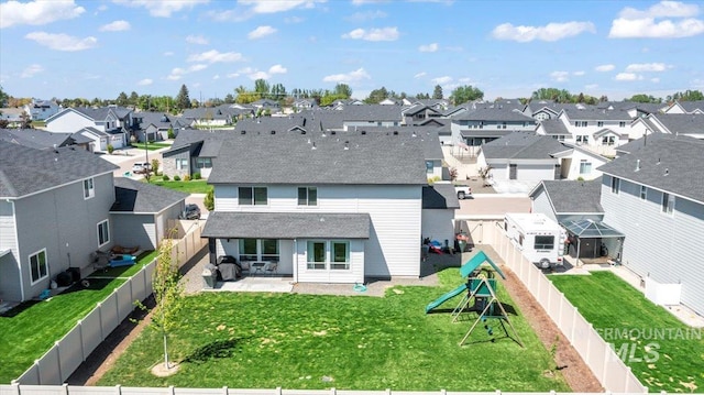 1499 W Blue Downs St, Meridian, ID 83642 - back of house featuring a residential view, a playground, a patio area, and a shingled roof