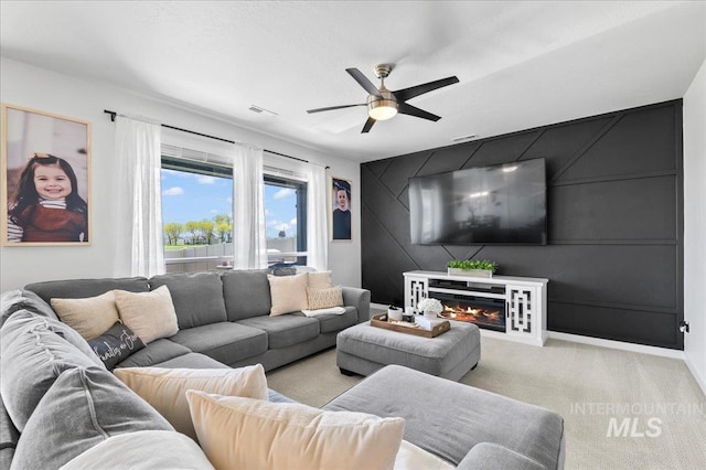 1499 W Blue Downs St, Meridian, ID 83642 - living area with a ceiling fan, an accent wall, light colored carpet, and a glass covered fireplace