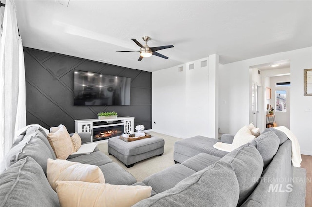 1499 W Blue Downs St, Meridian, ID 83642 - living area with baseboards, ceiling fan, and a glass covered fireplace