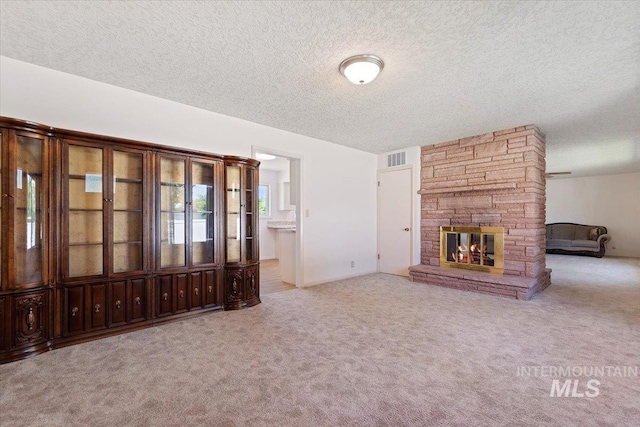 611 E Dewey Ln, Caldwell, ID 83607 - unfurnished living room with a textured ceiling, carpet floors, and a fireplace