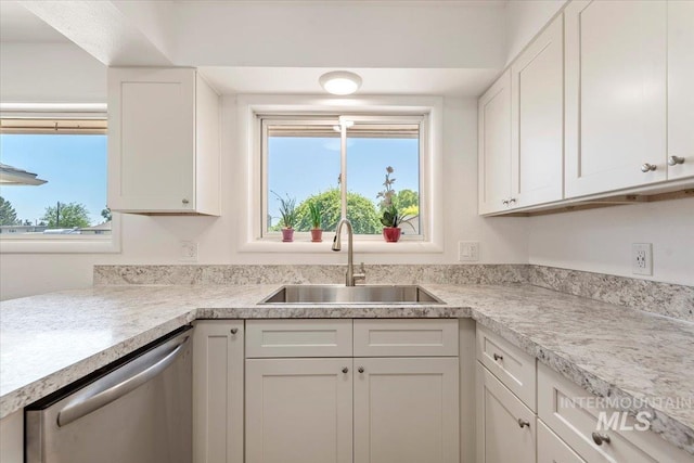611 E Dewey Ln, Caldwell, ID 83607 - kitchen with stainless steel dishwasher, healthy amount of natural light, white cabinetry, and light countertops