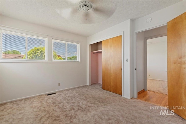 611 E Dewey Ln, Caldwell, ID 83607 - unfurnished bedroom with carpet flooring, a closet, a textured ceiling, and ceiling fan