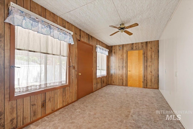 611 E Dewey Ln, Caldwell, ID 83607 - carpeted spare room with ceiling fan and wood walls