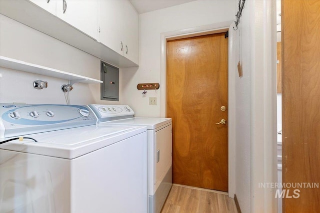 611 E Dewey Ln, Caldwell, ID 83607 - washroom with electric panel, cabinet space, washer and clothes dryer, and light wood-style floors