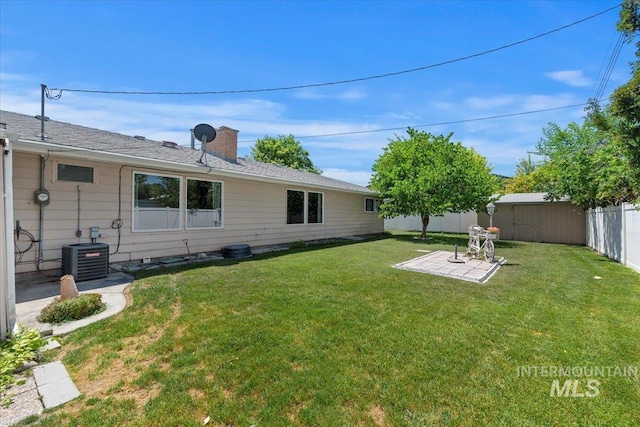 611 E Dewey Ln, Caldwell, ID 83607 - fenced backyard featuring a storage unit and a patio
