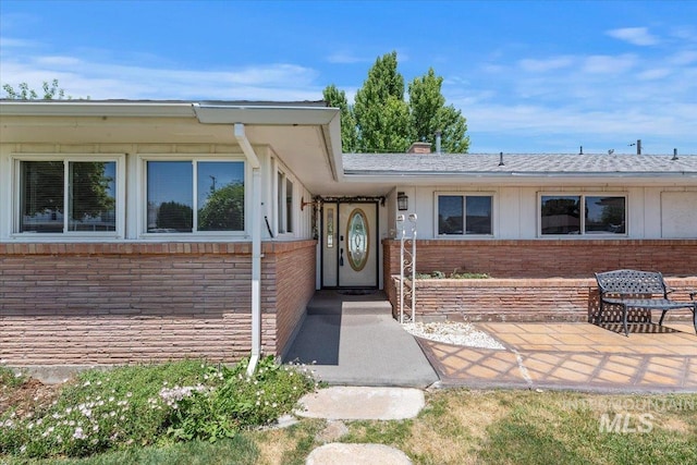 611 E Dewey Ln, Caldwell, ID 83607 - doorway to property with brick siding and roof with shingles
