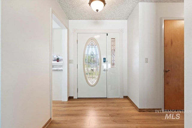 611 E Dewey Ln, Caldwell, ID 83607 - entryway with light wood-style floors and baseboards