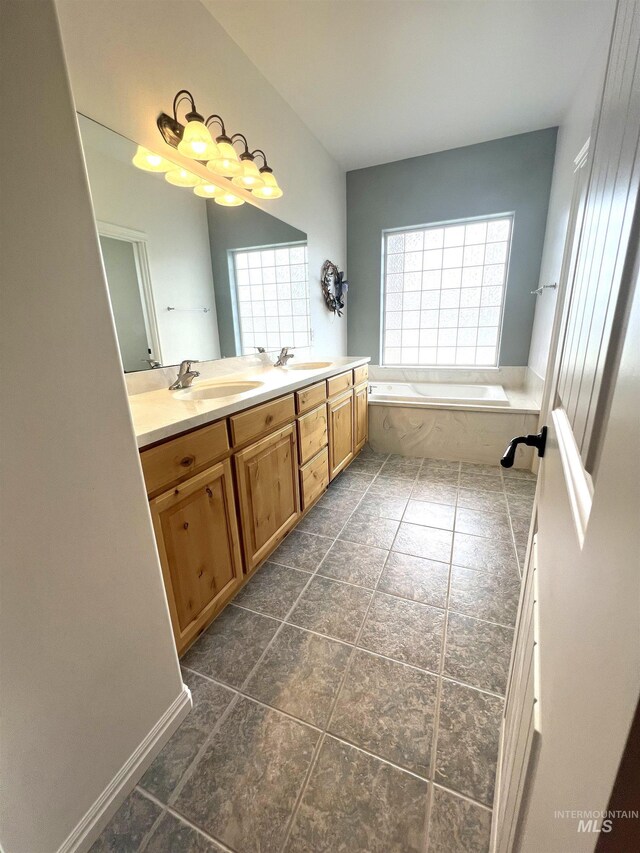 554 Valley Circle Rd, Hagerman, ID 83332 - full bathroom featuring double vanity, a bath, and tile patterned floors