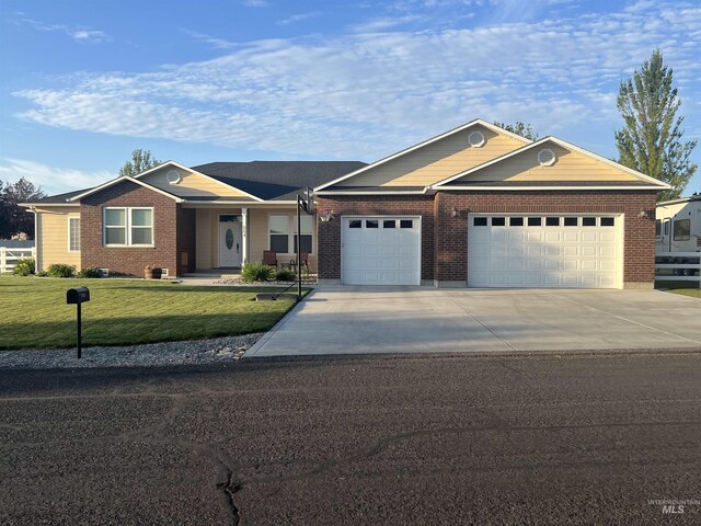 554 Valley Circle Rd, Hagerman, ID 83332 - single story home with an attached garage, driveway, a front yard, and brick siding