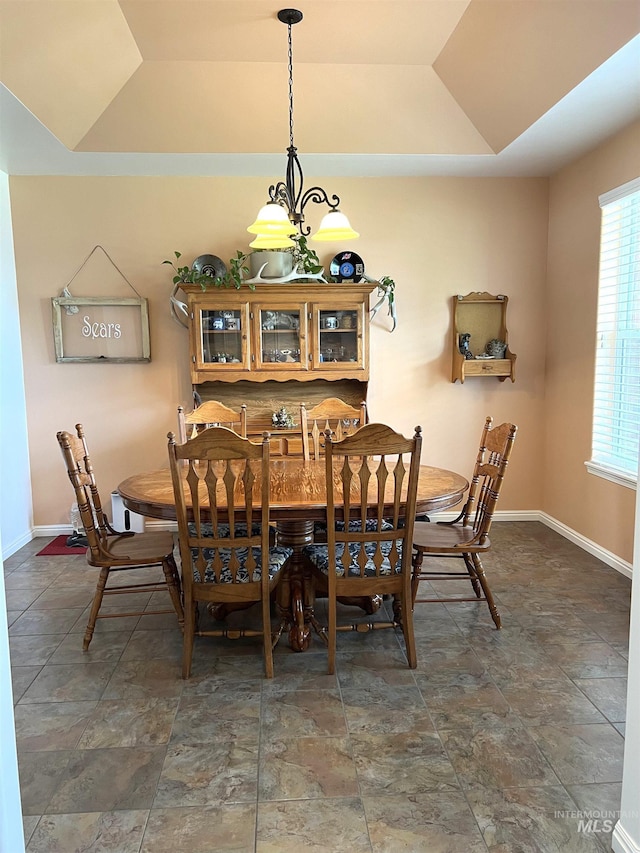 554 Valley Circle Rd, Hagerman, ID 83332 - dining room with a tray ceiling, a chandelier, baseboards, stone finish flooring, and lofted ceiling