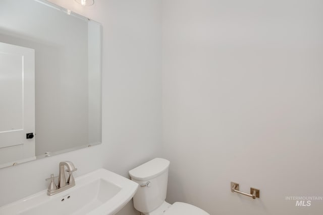 half bath with a sink and toilet
