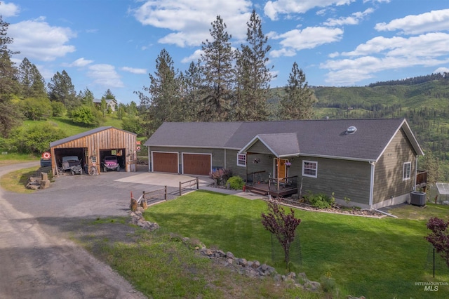 ranch-style home featuring a carport, a front yard, and central AC unit