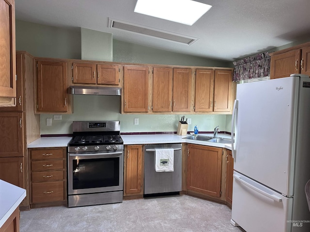 17121 Basey St, Murphy, ID 83650 - kitchen featuring stainless steel appliances, under cabinet range hood, a sink, light countertops, and brown cabinets