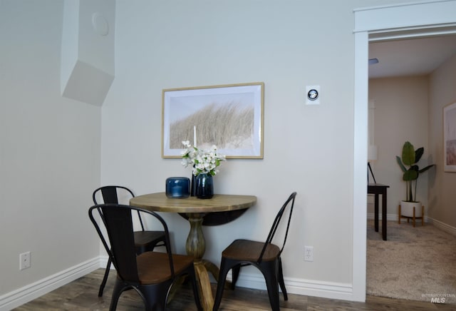 dining area featuring baseboards and wood finished floors