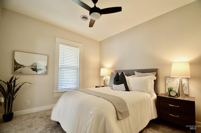 bedroom with baseboards, ceiling fan, dark carpet, and visible vents
