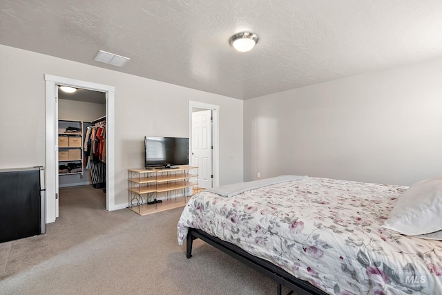 bedroom with light carpet, baseboards, a spacious closet, visible vents, and a closet