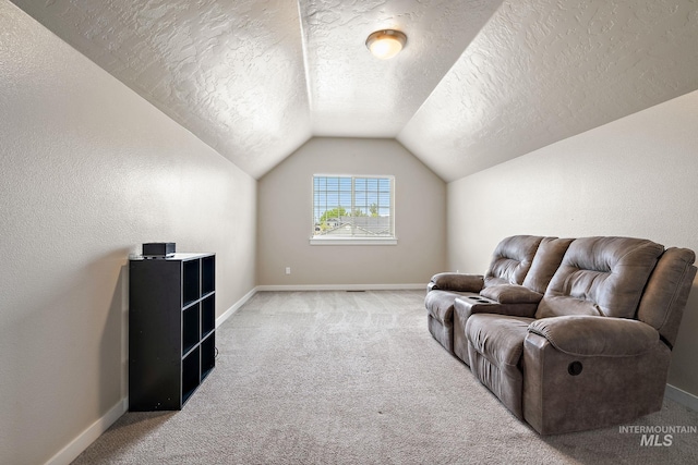 living area with baseboards, carpet, a textured ceiling, and lofted ceiling