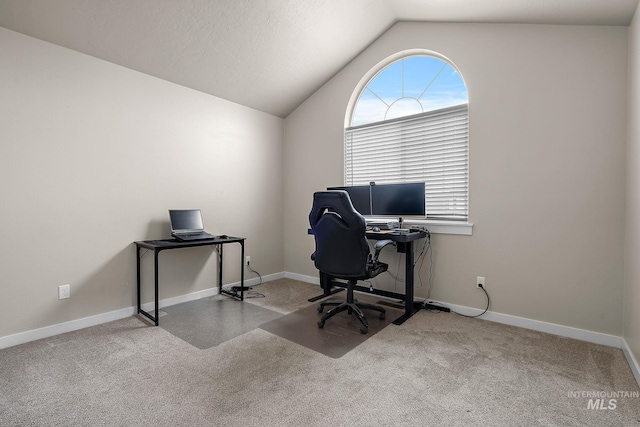 office area with carpet flooring, baseboards, and lofted ceiling