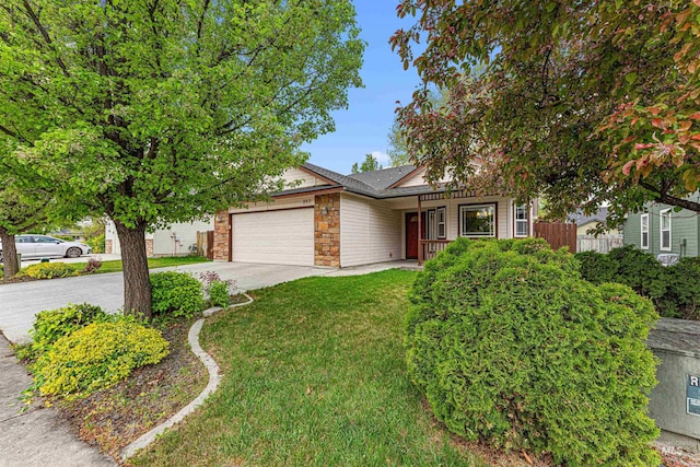view of property hidden behind natural elements with a garage, a front lawn, fence, stone siding, and concrete driveway