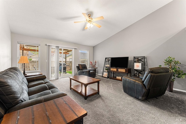 carpeted living room with a ceiling fan, baseboards, vaulted ceiling, and a wealth of natural light