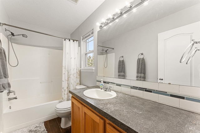 full bathroom with vanity, wood finished floors, toilet, a textured ceiling, and shower / tub combo
