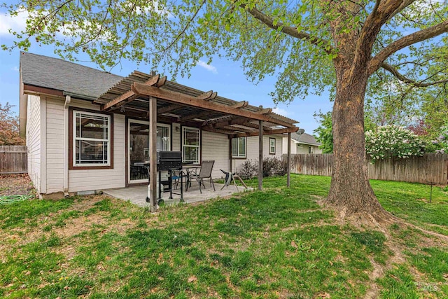 back of house with a fenced backyard, a pergola, a lawn, and a patio area