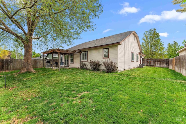 back of property with a yard, a pergola, a fenced backyard, and a patio area