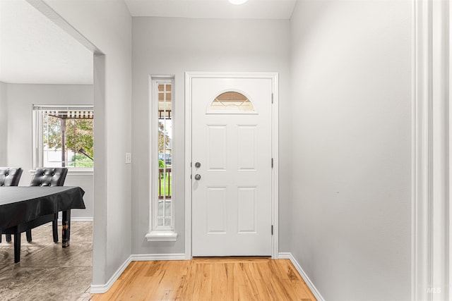 entrance foyer with baseboards and light wood-style floors
