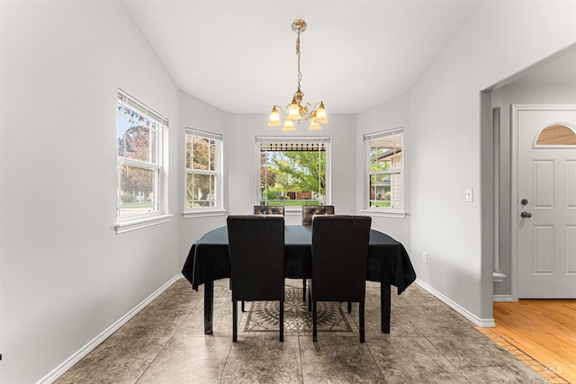 dining room featuring an inviting chandelier and baseboards