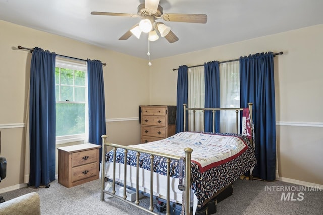 bedroom with light carpet, a ceiling fan, and baseboards