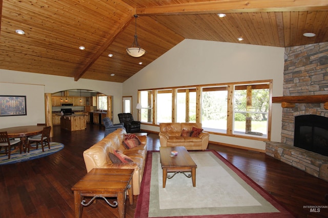 19801 Pinehaven Ln, Lenore, ID 83541 - living room with high vaulted ceiling, dark wood-style flooring, arched walkways, a stone fireplace, and plenty of natural light