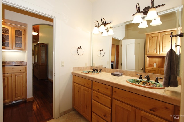 19801 Pinehaven Ln, Lenore, ID 83541 - bathroom with a chandelier, double vanity, and wood finished floors