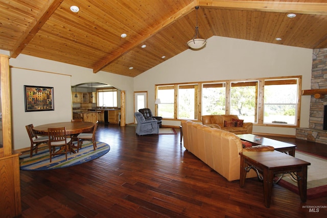 19801 Pinehaven Ln, Lenore, ID 83541 - living room with arched walkways, high vaulted ceiling, dark wood-type flooring, recessed lighting, and a stone fireplace