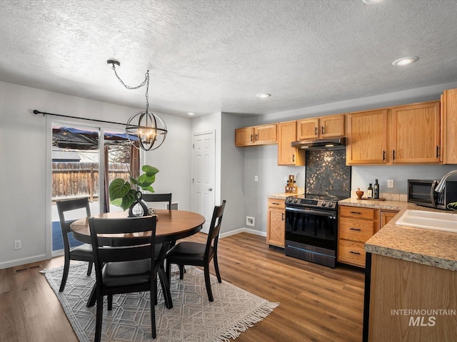 12800 W Fernleaf St, Boise, ID 83713 - dining space with wood finished floors, a chandelier, recessed lighting, and a textured ceiling