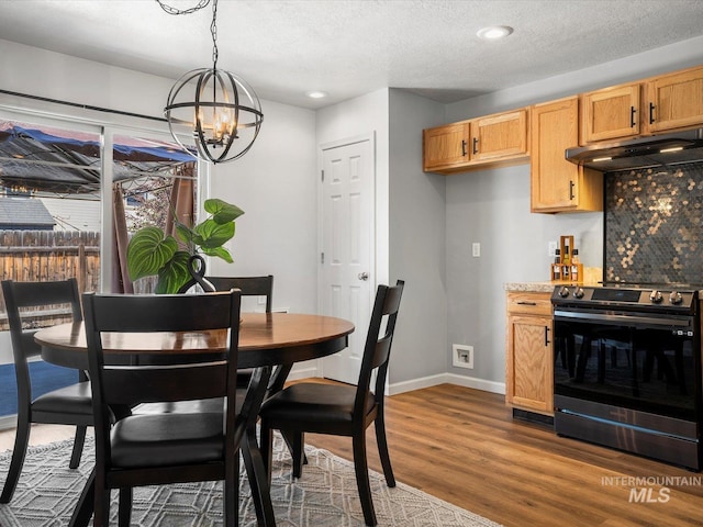 12800 W Fernleaf St, Boise, ID 83713 - dining area featuring a chandelier, wood finished floors, recessed lighting, and a textured ceiling
