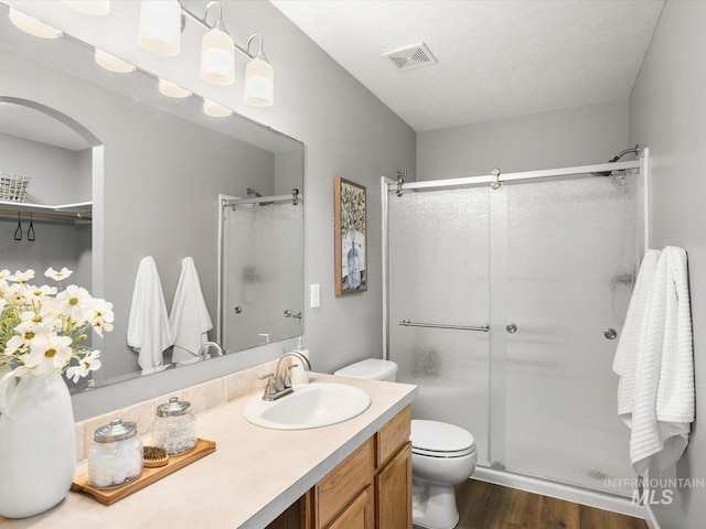 12800 W Fernleaf St, Boise, ID 83713 - full bathroom featuring a shower stall, wood finished floors, and vanity