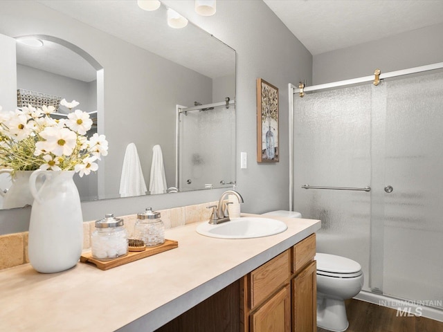 12800 W Fernleaf St, Boise, ID 83713 - full bath with a stall shower, vanity, and wood finished floors