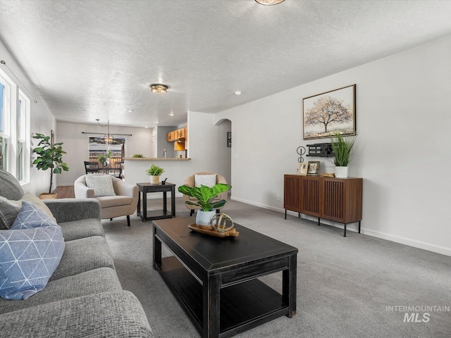 12800 W Fernleaf St, Boise, ID 83713 - carpeted living area featuring arched walkways and a textured ceiling