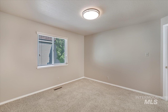 255 Los Lagos, Twin Falls, ID 83301 - carpeted empty room featuring baseboards and a textured ceiling