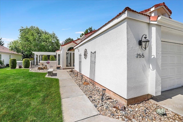 255 Los Lagos, Twin Falls, ID 83301 - view of side of property with a yard, stucco siding, and a tile roof