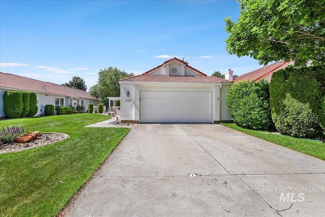 255 Los Lagos, Twin Falls, ID 83301 - view of front facade with a front lawn, a garage, stucco siding, driveway, and a tile roof