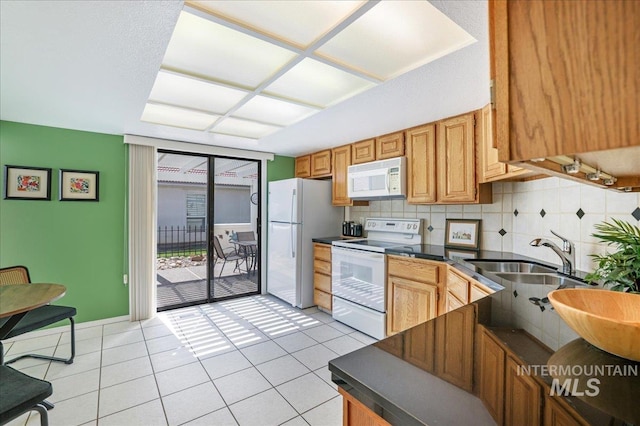 255 Los Lagos, Twin Falls, ID 83301 - kitchen with white appliances, a sink, dark countertops, and light tile patterned floors