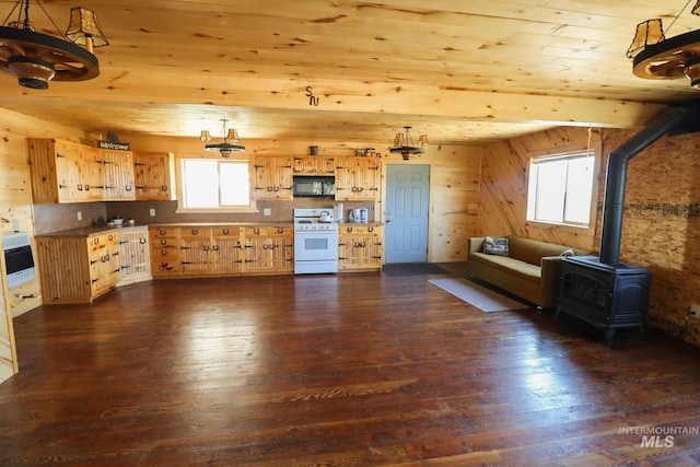 kitchen featuring decorative light fixtures, a wood stove, white gas range, and dark hardwood / wood-style flooring