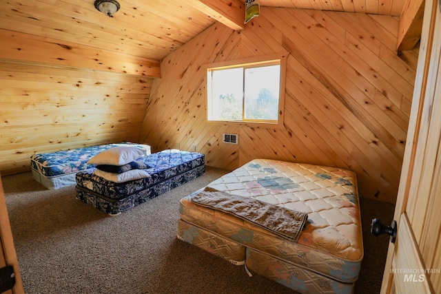 carpeted bedroom with lofted ceiling with beams, wooden walls, and visible vents
