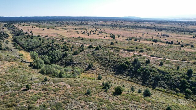 birds eye view of property with a rural view