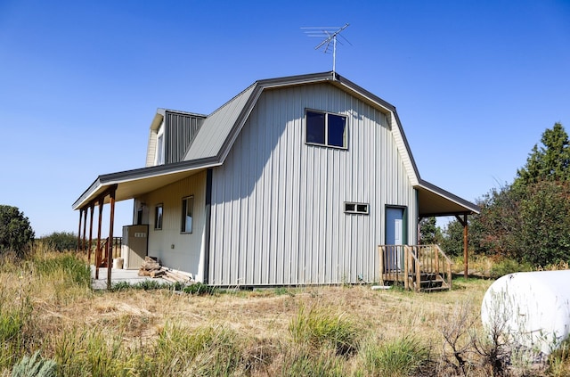 view of property exterior with a gambrel roof
