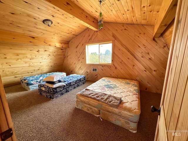 bedroom featuring carpet flooring, visible vents, and wooden walls
