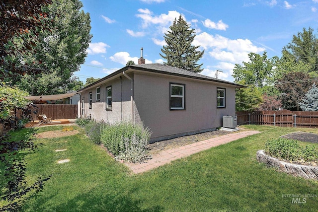 3209 W Plant Dr, Boise, ID 83703 - rear view of property with stucco siding, central AC, and a chimney