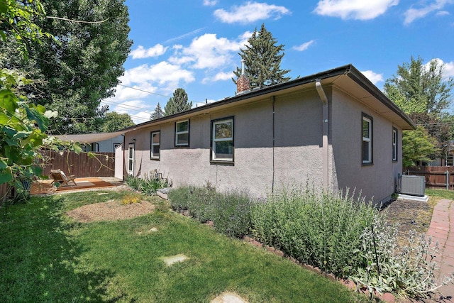3209 W Plant Dr, Boise, ID 83703 - view of side of home with stucco siding, central AC, a chimney, and a patio area